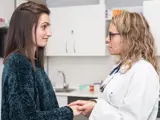 Teenage girl meeting with her pediatrician during an adolescent care visit