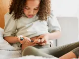 Child resting in bed while managing a chronic condition